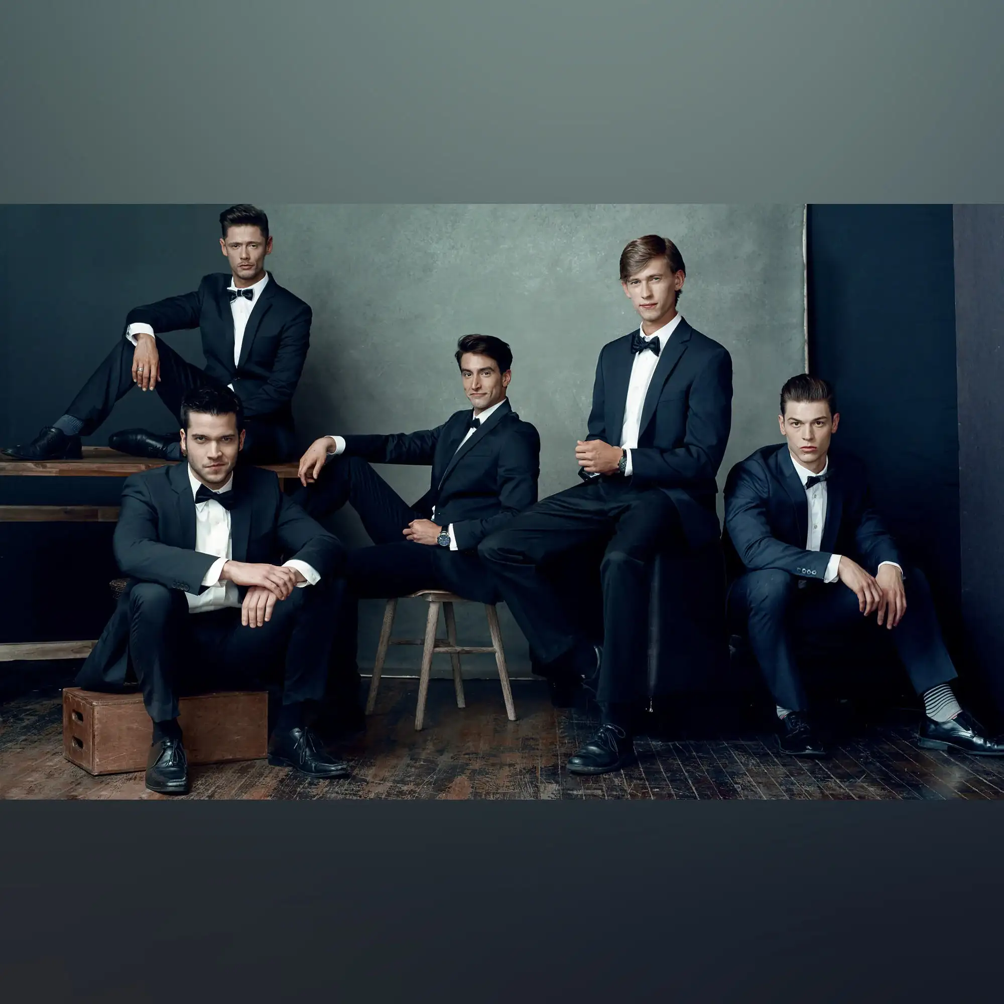 Timeless elegant gentlemens group portrait in tuxedos
